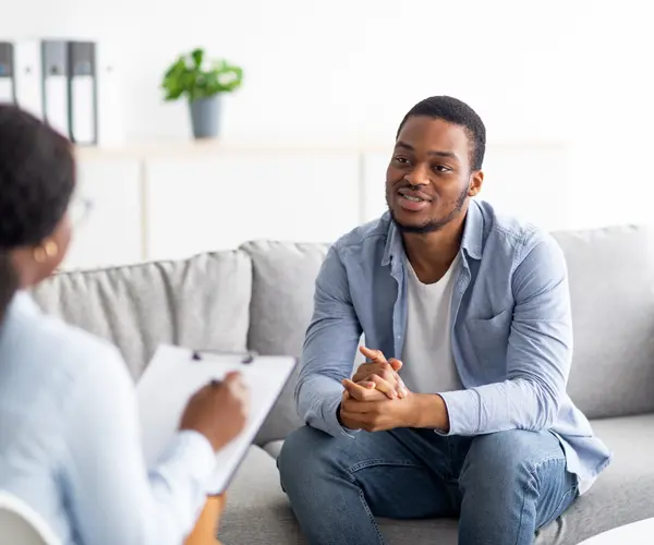 man speaking to therapist