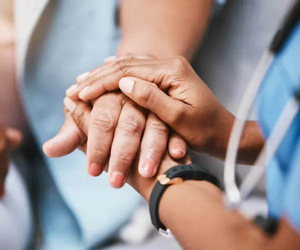 nurse holding hands with patient